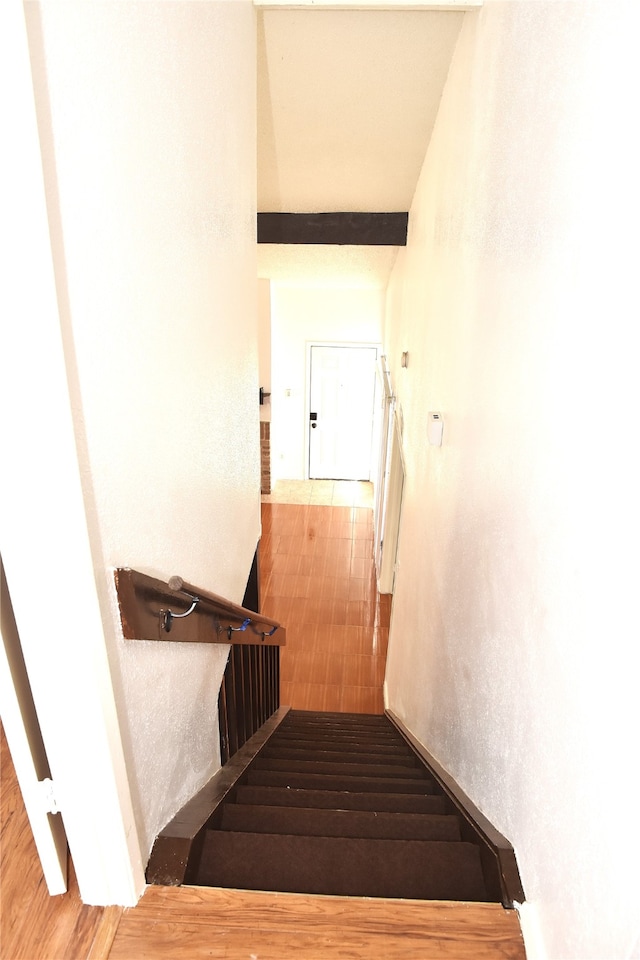 stairway featuring wood-type flooring