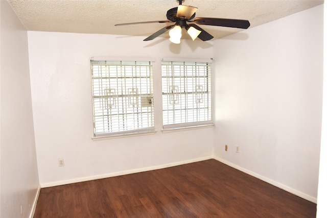 spare room featuring dark hardwood / wood-style flooring, a textured ceiling, and ceiling fan