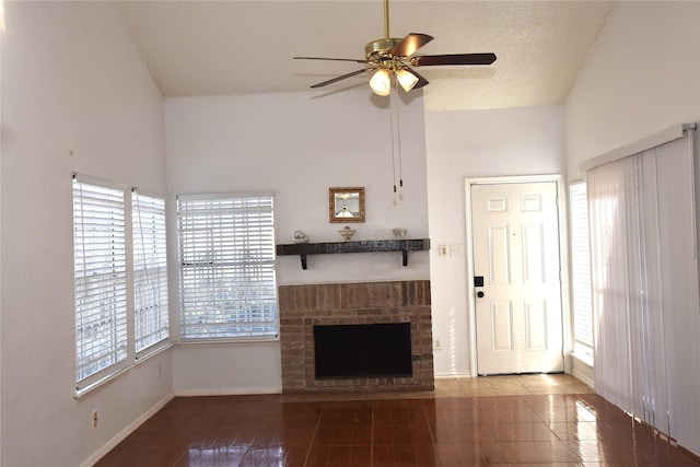 12264 Bob White Dr Unit 122, Houston, TX 77035 - unfurnished living room with baseboards, ceiling fan, tile patterned floors, high vaulted ceiling, and a fireplace