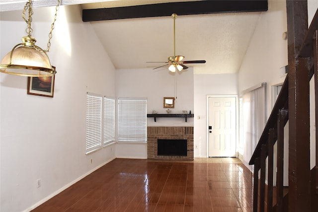 unfurnished living room featuring a brick fireplace, a textured ceiling, high vaulted ceiling, beamed ceiling, and ceiling fan