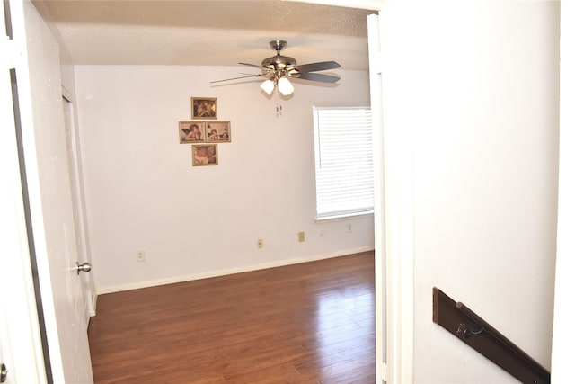 spare room featuring dark hardwood / wood-style flooring, lofted ceiling, a textured ceiling, and ceiling fan