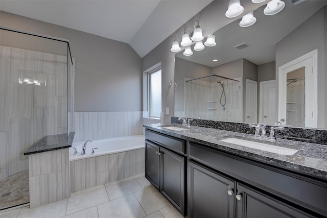 bathroom with shower with separate bathtub, lofted ceiling, tile patterned floors, and vanity