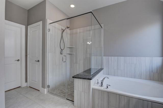 bathroom with tile patterned flooring and independent shower and bath