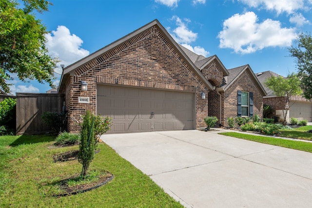 view of front of property with a garage and a front yard