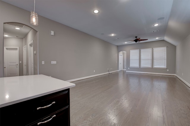 unfurnished living room with hardwood / wood-style floors, ceiling fan, and lofted ceiling