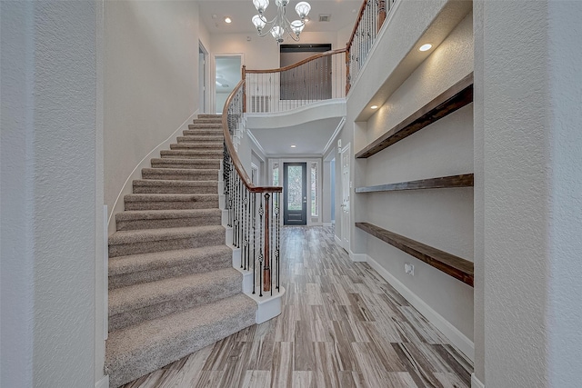 entryway featuring an inviting chandelier and hardwood / wood-style flooring