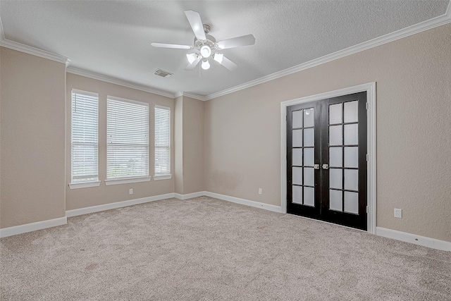 empty room with light carpet, french doors, ceiling fan, and a textured ceiling