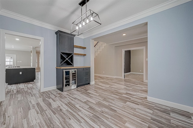 bar with light hardwood / wood-style floors, crown molding, and wine cooler