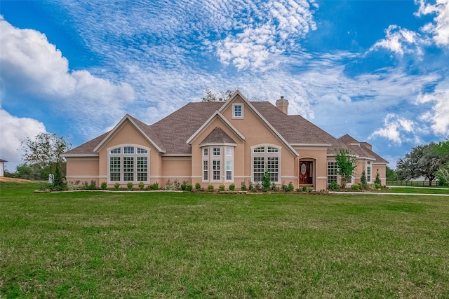 1810 Mccrary Rd, Richmond, TX 77406 - view of front of home featuring stucco siding, a front yard, and a chimney