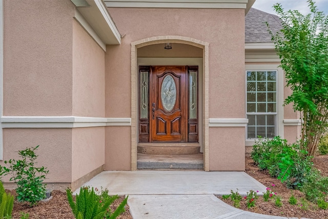 1810 Mccrary Rd, Richmond, TX 77406 - view of exterior entry with stucco siding and roof with shingles