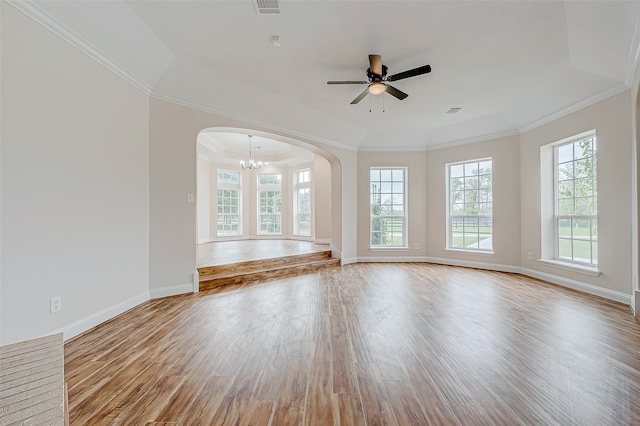 empty room with light hardwood / wood-style floors, ceiling fan with notable chandelier, and ornamental molding