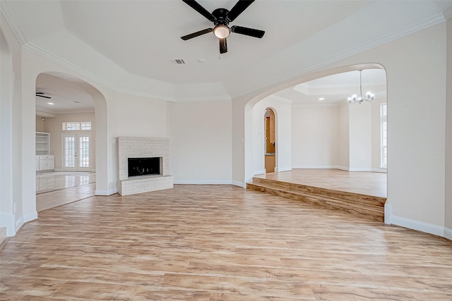 1810 Mccrary Rd, Richmond, TX 77406 - unfurnished living room featuring a ceiling fan, light wood-style floors, ornamental molding, baseboards, and a tray ceiling
