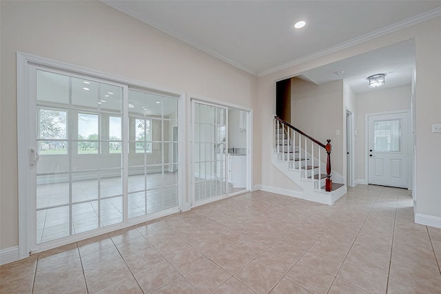 doorway to outside with crown molding and light tile patterned flooring