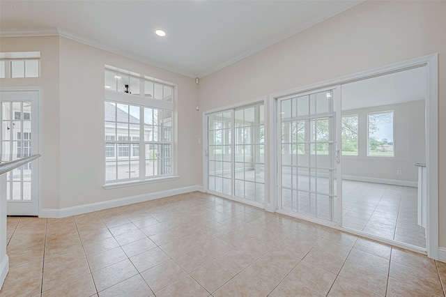 empty room featuring crown molding and light tile patterned floors