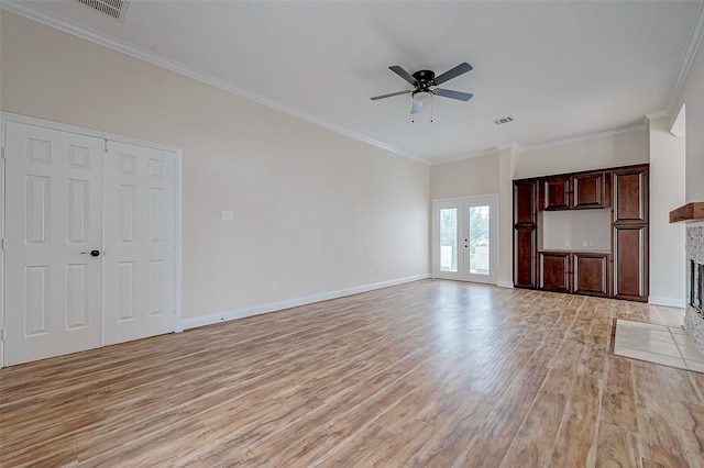 unfurnished living room with french doors, crown molding, ceiling fan, a fireplace, and light hardwood / wood-style floors