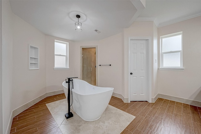 1810 Mccrary Rd, Richmond, TX 77406 - full bathroom featuring a freestanding tub, plenty of natural light, wood finished floors, ornamental molding, and baseboards