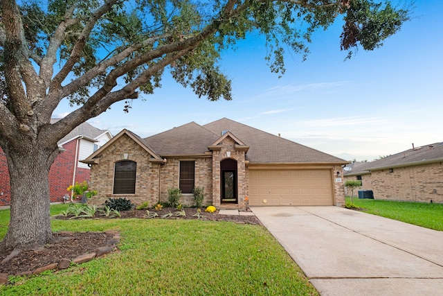 view of front of home with a front lawn and a garage