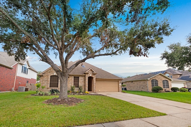 ranch-style house featuring a garage, central AC, and a front yard