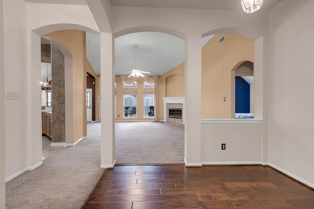 interior space featuring a fireplace and ceiling fan with notable chandelier