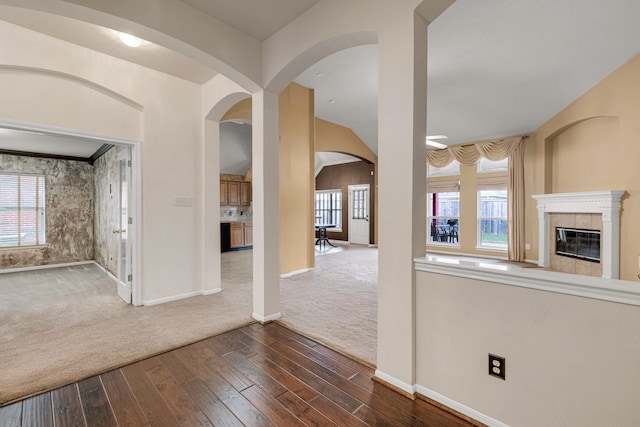 entrance foyer featuring a tiled fireplace and dark wood-type flooring