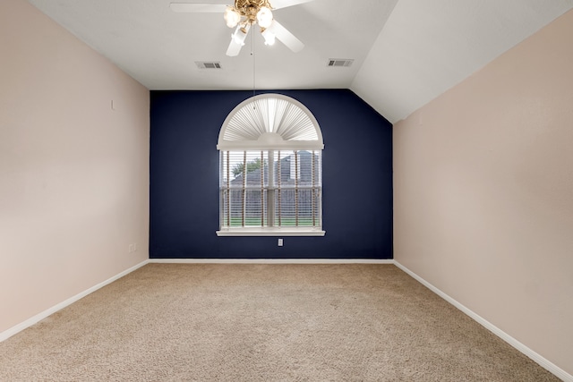 unfurnished room with carpet, vaulted ceiling, and ceiling fan