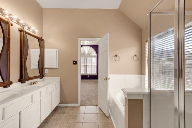 bathroom featuring vanity, independent shower and bath, lofted ceiling, and tile patterned floors