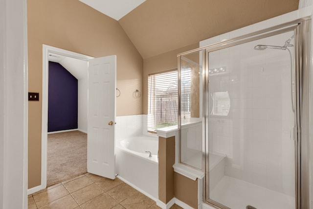 bathroom with shower with separate bathtub, vaulted ceiling, and tile patterned floors