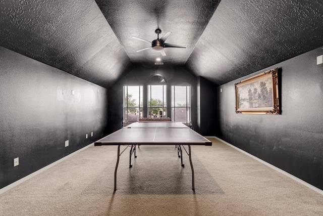 rec room featuring ceiling fan, a textured ceiling, lofted ceiling, and carpet