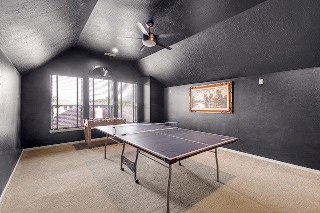 game room with vaulted ceiling, carpet flooring, ceiling fan, and a textured ceiling