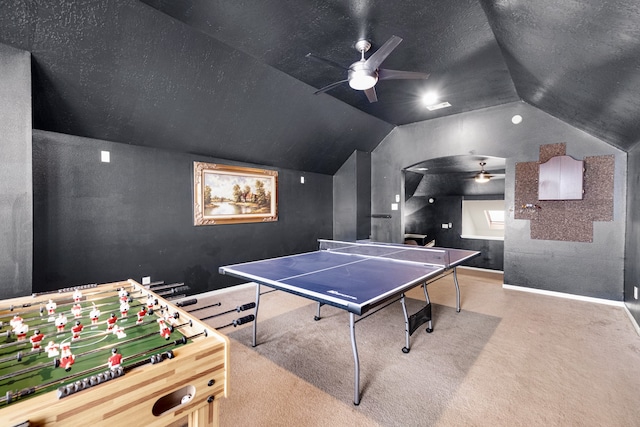 recreation room featuring ceiling fan, a textured ceiling, vaulted ceiling, and carpet