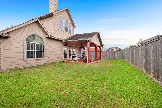 back of house with a patio, a lawn, and ceiling fan