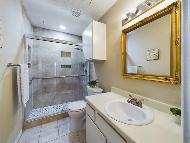 10855 Meadowglen Ln Unit 1112, Houston, TX 77042 - full bathroom featuring toilet, vanity, a stall shower, tile patterned floors, and a textured ceiling