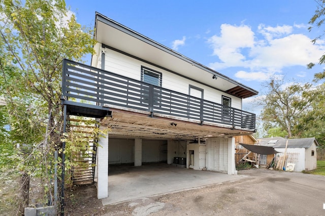 213 Super St, Houston, TX 77011 - view of home's exterior featuring a storage shed, an attached garage, driveway, and an outdoor structure