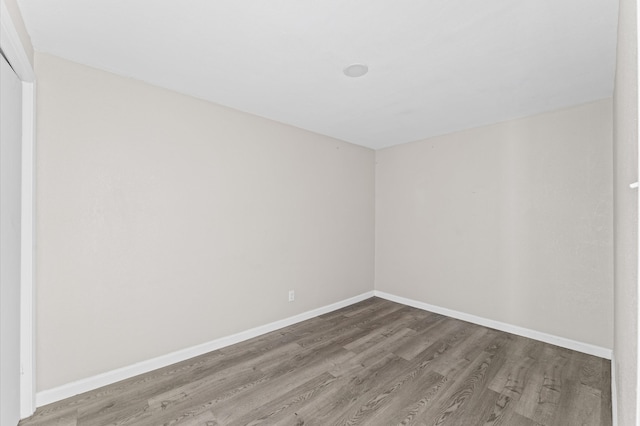 spare room with wood-type flooring