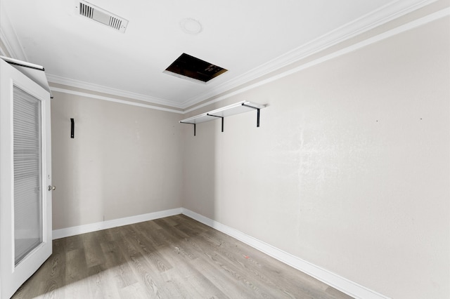 empty room with hardwood / wood-style flooring and ornamental molding