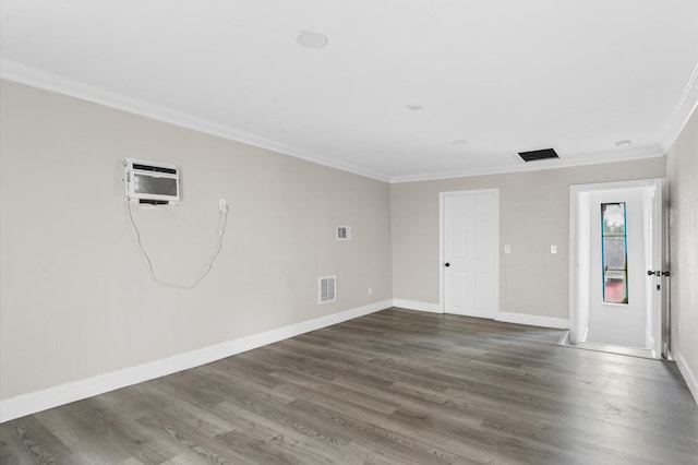 213 Super St, Houston, TX 77011 - empty room featuring a wall mounted air conditioner, crown molding, wood finished floors, and baseboards