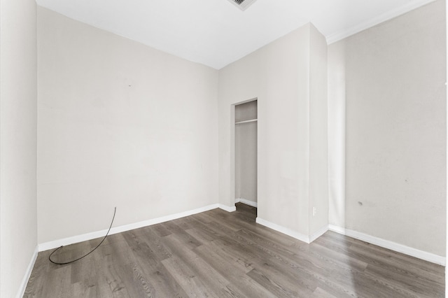 unfurnished bedroom with dark wood-type flooring