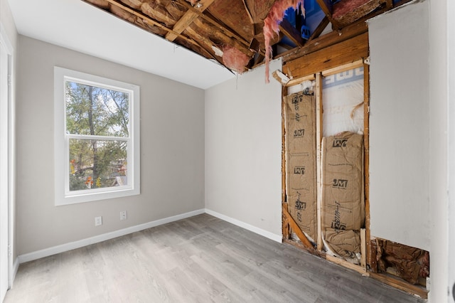 unfurnished room with hardwood / wood-style flooring