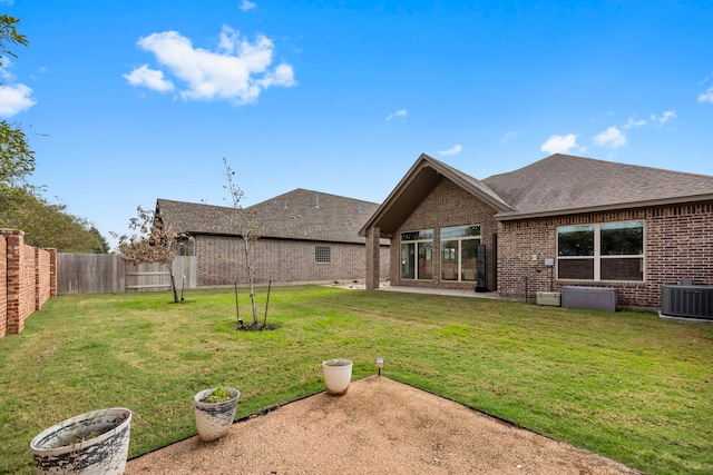 2215 Rose Manor Ct, Richmond, TX 77469 - rear view of property featuring brick siding, central AC, a patio area, and roof with shingles
