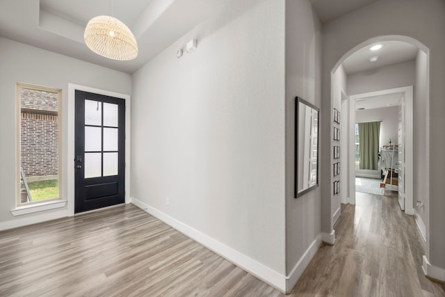 2215 Rose Manor Ct, Richmond, TX 77469 - foyer entrance featuring arched walkways, wood finished floors, baseboards, and healthy amount of natural light