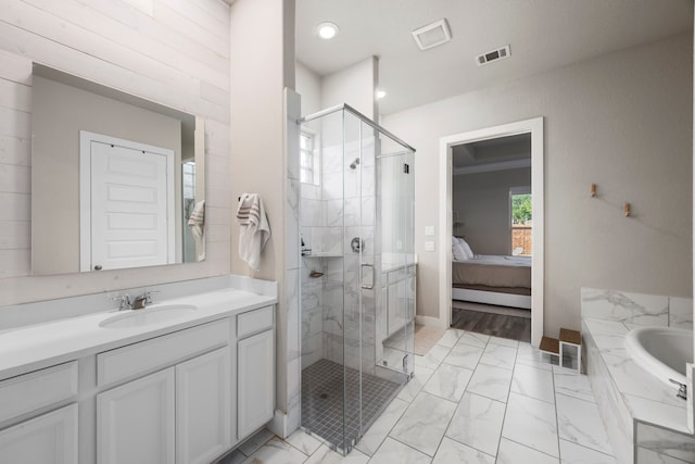 2215 Rose Manor Ct, Richmond, TX 77469 - ensuite bathroom featuring vanity, a garden tub, a stall shower, marble look tile flooring, and recessed lighting