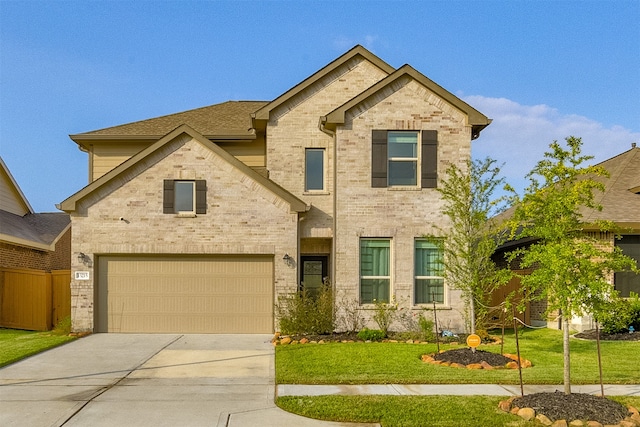 view of front of home with a garage and a front lawn