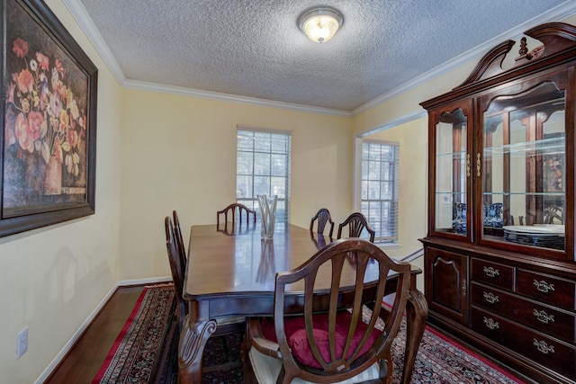 dining room with ornamental molding, dark hardwood / wood-style floors, and a textured ceiling