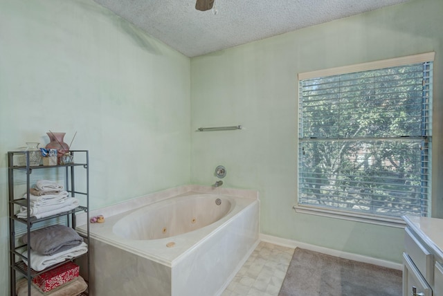 bathroom featuring a textured ceiling and a tub to relax in