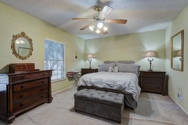 carpeted bedroom featuring ceiling fan and a textured ceiling