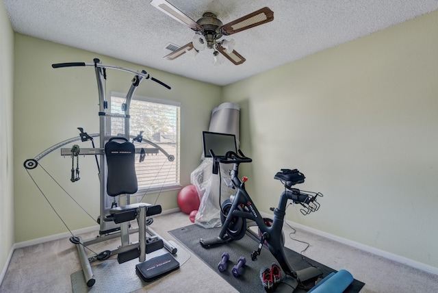 workout area featuring a textured ceiling and carpet