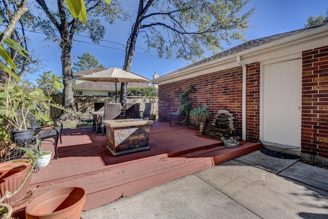 wooden deck with a fire pit