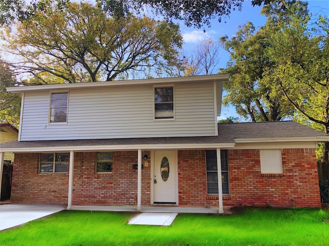 view of property featuring a front yard and a patio area