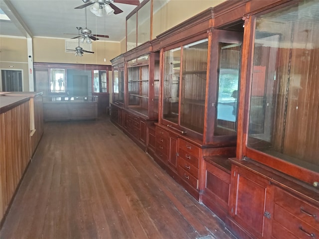 hallway featuring dark wood-type flooring and crown molding