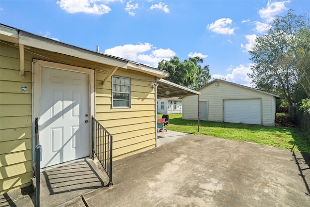 exterior space with a garage and an outbuilding